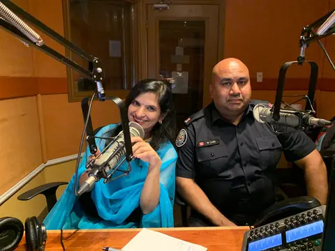 Swati with a police officer at the studio microphones