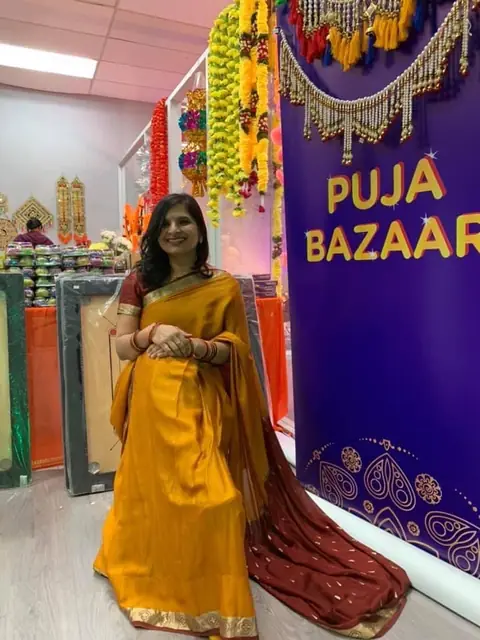 Swati in a yellow outfit at a Puja Bazaar stall