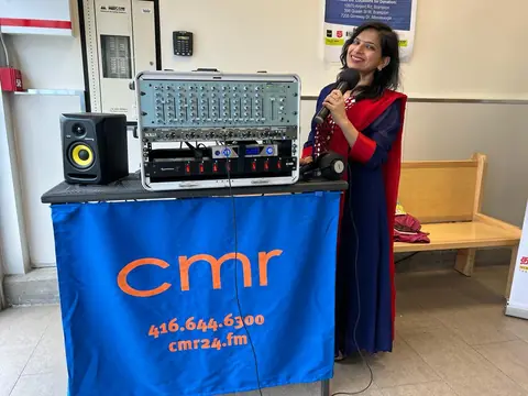 Swati with the CMR live broadcast setup, speakers and mixer