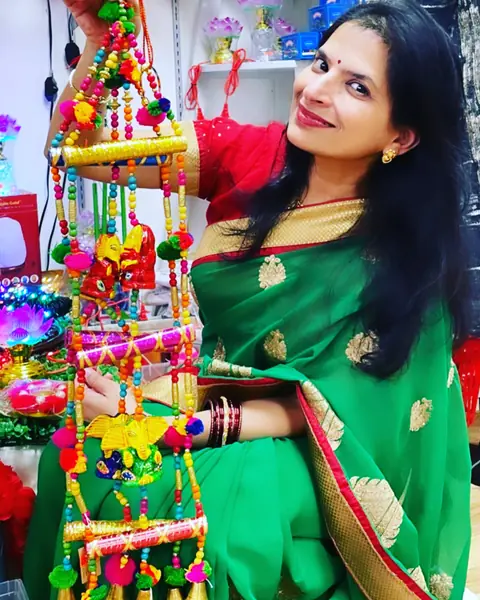 Swati in a green sari among colourful festive decorations