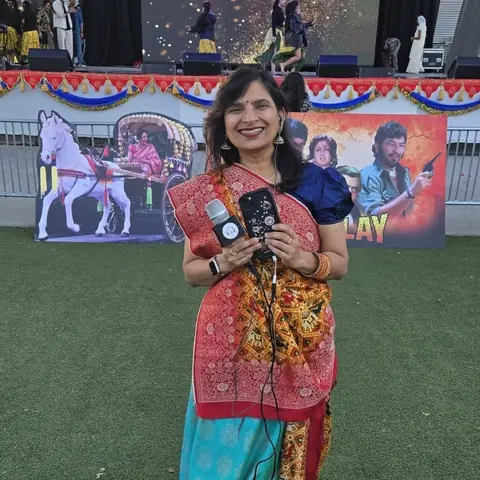 RJ Swati with microphones in front of the stage at Canada Diwali RazzMatazz 2025